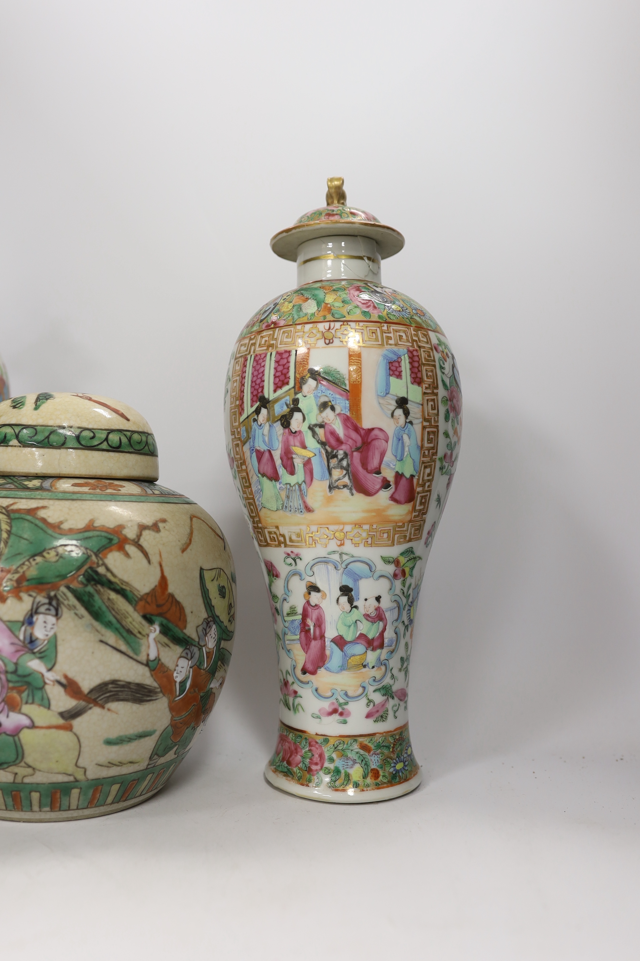 A pair of 19th century Chinese famille rose vases and covers, a similar small vase and a a famille verte crackle glaze jar, tallest 31cm